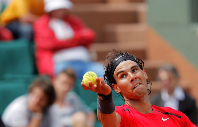 Rafael Nadal of Spain serves to Denis Istomin of Uzbekistan during the French Open tennis tournament at the Roland Garros stadium in Paris May 31, 2012. REUTERS/Gonzalo Fuentes (FRANCE - Tags: SPORT TENNIS) TENNIS-OPEN/