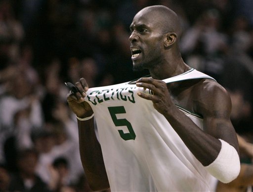 Boston Celtics forward Kevin Garnett (5) grabs his jersey as he celebrates while pulling away from the Philadelphia 76ers during the second half of their NBA basketball game in Boston, Friday Jan. 18, 2008. The Celtics beat the Sixers, 116-89. (AP Photo/Charles Krupa)