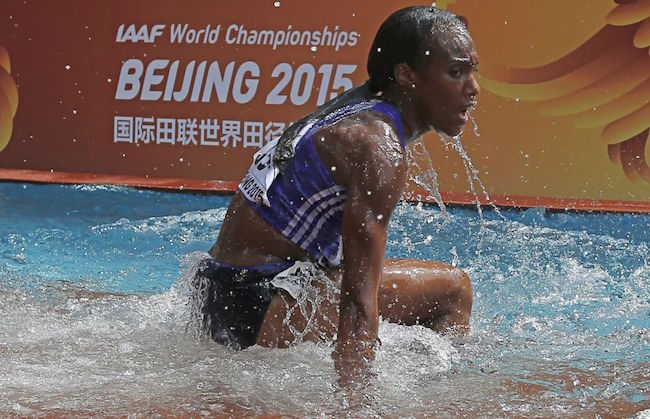Panama's Rolanda Bell gets up after falling into the water jump during the heats of the women's 3,000 metres steeplechase athletics event at the 2015 IAAF World Championships at the "Bird's Nest" National Stadium in Beijing on August 24, 2015. AFP PHOTO / ADRIAN DENNIS