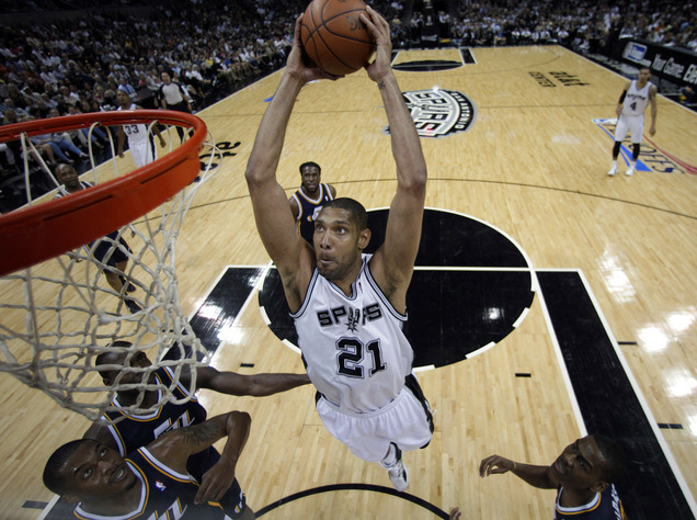 San Antonio Spurs' Tim Duncan (21) drives to the basket over Utah Jazz defenders during the first half of Game 1 of a first-round NBA basketball playoff series on Sunday, April 29, 2012, in San Antonio. San Antonio won 106-91.(AP Photo/Eric Gay)