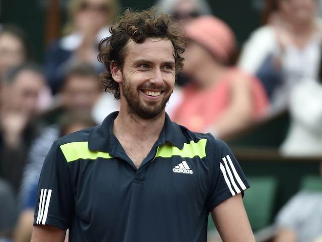 Latvia's Ernests Gulbis reacts after a point during his French tennis Open round of sixteen match against Switzerland's Roger Federer at the Roland Garros stadium in Paris on June 1, 2014. AFP PHOTO / PASCAL GUYOT (Photo credit should read PASCAL GUYOT/AFP/Getty Images)