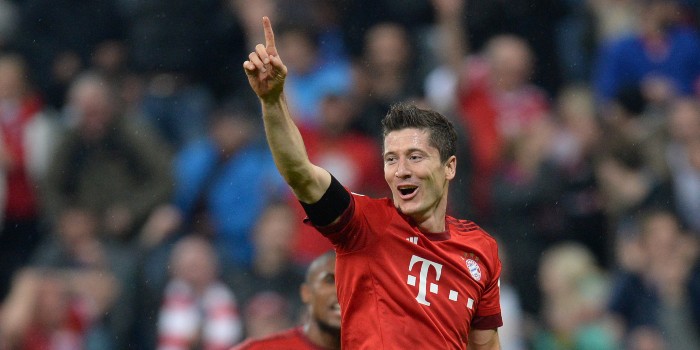 Bayern Munich's Polish striker Robert Lewandowski celebrates after his fifth goal for Munich during the German first division Bundesliga football match FC Bayern Muenchen vs VfL Wolfsburg in Munich, on September 22, 2015. AFP PHOTO / CHRISTOF STACHE RESTRICTIONS: DURING MATCH TIME: DFL RULES TO LIMIT THE ONLINE USAGE TO 15 PICTURES PER MATCH AND FORBID IMAGE SEQUENCES TO SIMULATE VIDEO. ==RESTRICTED TO EDITORIAL USE == FOR FURTHER QUERIES PLEASE CONTACT THE DFL DIRECTLY AT + 49 69 650050.
