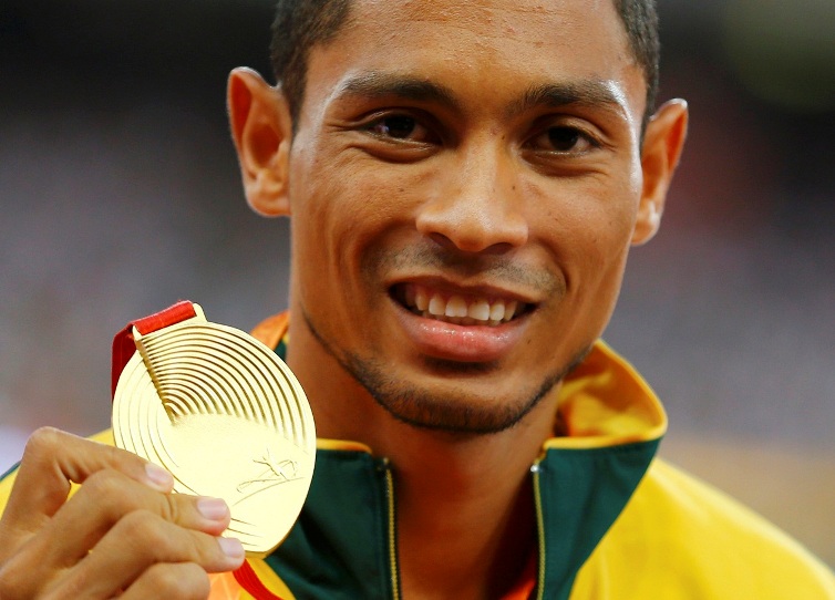 Wayde van Niekerk of South Africa presents his gold medal as he poses on the podium after the men's 400 metres final during the 15th IAAF World Championships at the National Stadium in Beijing, China, August 27, 2015. REUTERS/Damir Sagolj