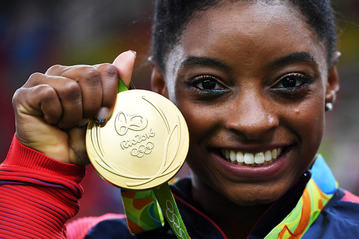 RIO DE JANEIRO, BRAZIL - AUGUST 09:  Simone Biles of the United States poses for photographs with her gold medal after the medal ceremony for the Artistic Gymnastics Women's Team on Day 4 of the Rio 2016 Olympic Games at the Rio Olympic Arena on August 9, 2016 in Rio de Janeiro, Brazil.  (Photo by Laurence Griffiths/Getty Images)